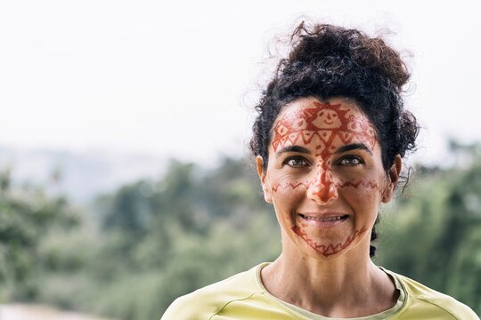 Smiling mature female with painting on face