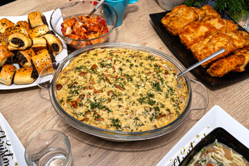 The table is set before Christmas dinner in Poland, visible baked cod fillets in chanterelle sauce.