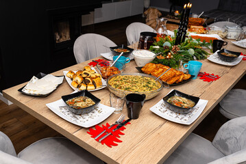 A table set before Christmas dinner with many traditional Polish dishes.
