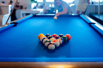 Blurred woman playing billiards game