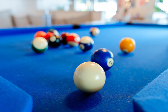 Colorful billiard balls on blue pool table