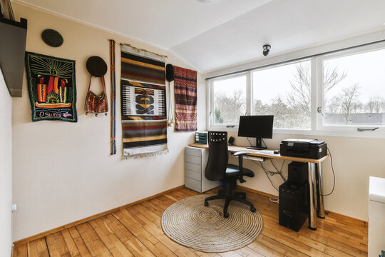 Home office with computer on desk by window