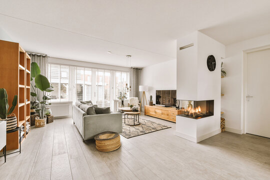 Modern living room with sofa and TV by fireplace