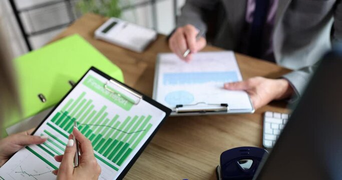Business people are discussing a financial report, hands close-up. Concept summing up, financial result