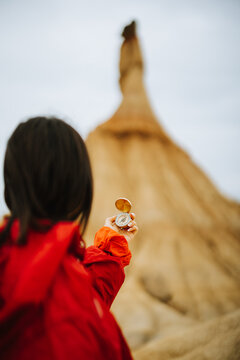 A person holding a compass in their hand