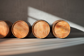 Wine, whiskey, or brandy wooden barrels storage. Rays of sunlight in a cellar