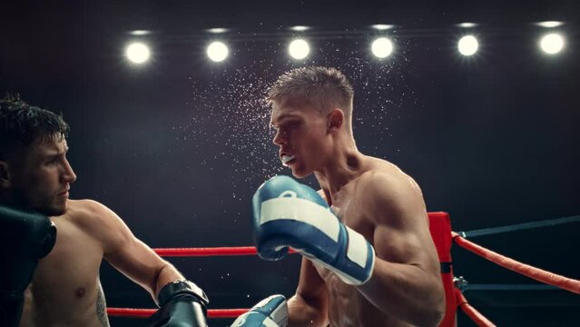 Professional Boxing Match in Super Slow Motion. Boxer Defending From a Punch and Countering with a Hook to the Jaw, Knocking Out the Opponent. Cinematic Footage with a Speed Ramp Action Effect