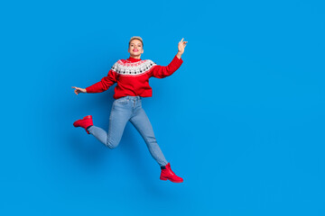 Fototapeta na wymiar Full body length size photo of nice attractive positive woman wear red ornament sweater jump hurry shopping mall isolated on blue color background