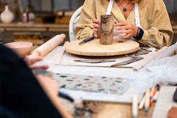 Ceramic Workshop. Middle-aged woman turning clay.