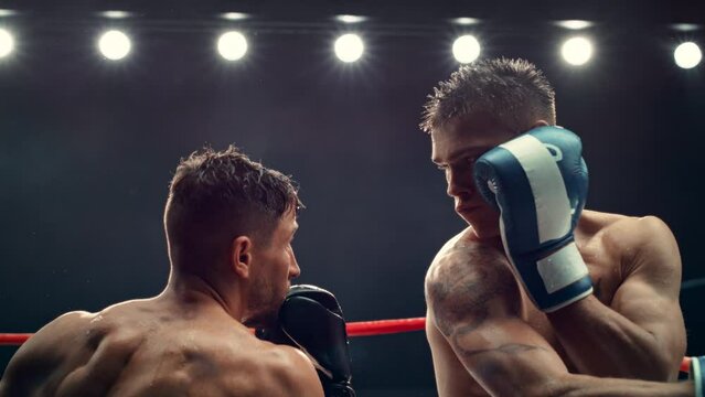 Exciting and Challenging Boxing Match in Super Slow Motion. Boxer Avoiding a Punch and Countering with a Hook to the Jaw, Rocking the Opponent. Cinematic Footage with a Speed Ramp Action Effect