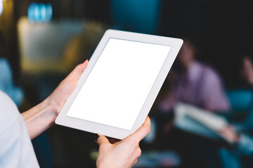 Crop female using tablet for work