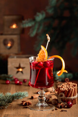 Hot Christmas drink with orange slices and spices.