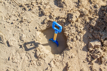 Isolated children's shovel for playing in the sand at a beach