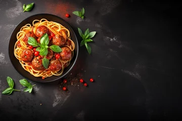 Fotobehang Top view copy space black bowl of spaghetti meatballs in tomato sauce on a dark slate © VolumeThings