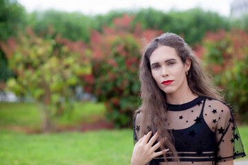 Naklejka premium Beautiful transgender woman with long hair in the city