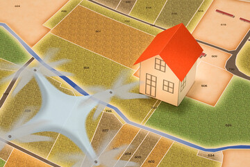 Top view of an imaginary city with buildings, roads and land parcel and a drone taking an aerial...