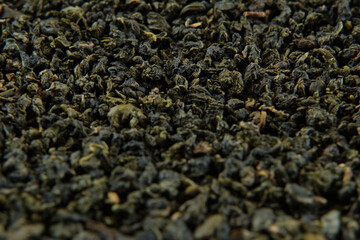 Black dry Tea Wallpaper. Mix Black and Green Tea Leaves rotating on Turntable. Close Up, Macro. Top...