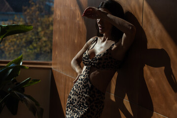 Woman in leopard print summer dress, tropical resort
