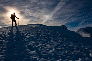 Hiker on top of a snowy hill in the Pyrenees