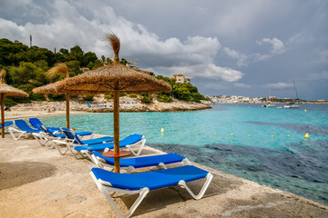 Beach umbrellas and chaise lounges at Playa de Illetes beach