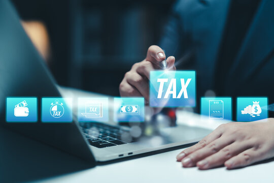 Businesswoman using the laptop to fill in the income tax online return form for payment. Financial research,government taxes and calculation tax return concept. Tax and Vat concept.