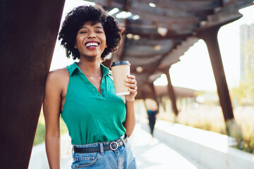 carefree andhappy African American hipster girl in casual wear enjoying sunny weather