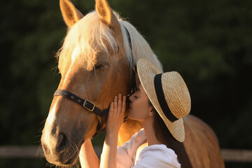 Woman with adorable horse outdoors. Lovely domesticated pet