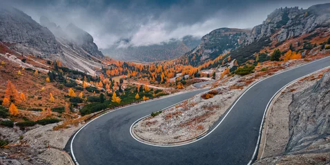 Stoff pro Meter Misty autumn view of Tre Cime Di Lavaredo National Park with  winding road. Gloomy evening scene of Dolomite Alps, Auronzo Di Cadore location, Italy, Europe. Beauty of nature concept background. © Andrew Mayovskyy