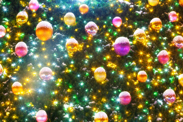 Fototapeta na wymiar Elegant Christmas fur-tree with colorful balls and lights