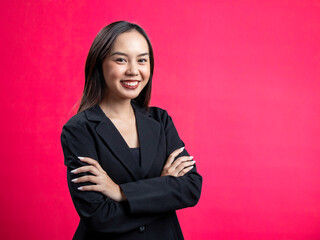Portrait of an Asian Indonesian woman wearing a black work shirt, confidently posing with her hands...