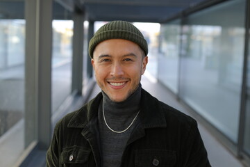 Handsome mixed ethnicity man smiling in urban setting