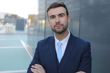 Fototapeta premium Powerful looking businessman crossing his arms 