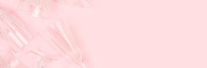 Banner with different crystal glasses on a pink background. Place for your design.