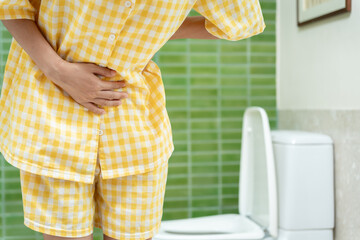 Constipation and diarrhea in bathroom. Hurt woman touch belly  stomach ache painful. colon...
