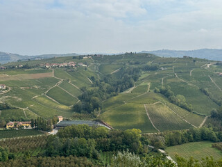 Fototapeta na wymiar Italian landscape in Langhe and Monferrato, vineyards are visible on the hills.