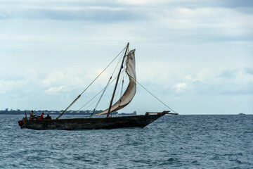 large transport dhow sailing along coastal waters heading for harbour