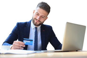 Smiling man sitting pays by credit card with his laptop on a transparent background