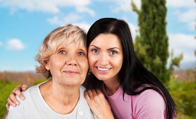 Couple of mother and adult child, laughing hug in park