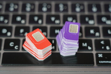 Many SIM cards on a laptop keyboard. Bot farm. Mobile gsm cards