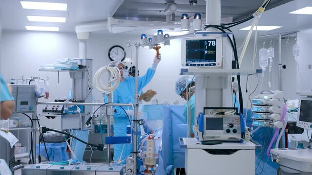 Professional surgeons prepare for heart surgery in a state-of-the-art surgery room. Nurses preparing equipment