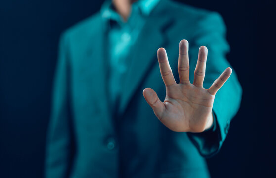 The man's hand showing palm gestures stop concept of refuse caution