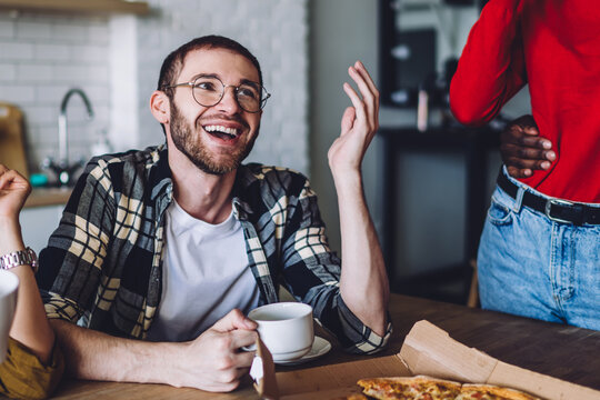 Young cheerful kith talking with coffee and fast food