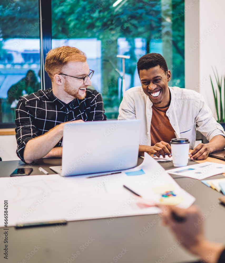Poster toothy coworkers discussing funny video from social platform enjoying break for positive networking