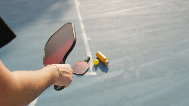 Playing with Pickleball racket in the court 