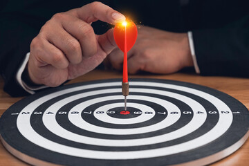 Targeting the business concept, Businessman throwing red arrow dart to virtual target dart...