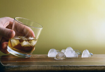 glass with whiskey and ice cubes