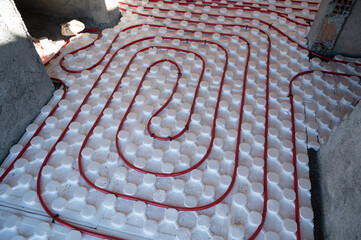 Underfloor heating system during construction of new house. Water pipes floor heating system