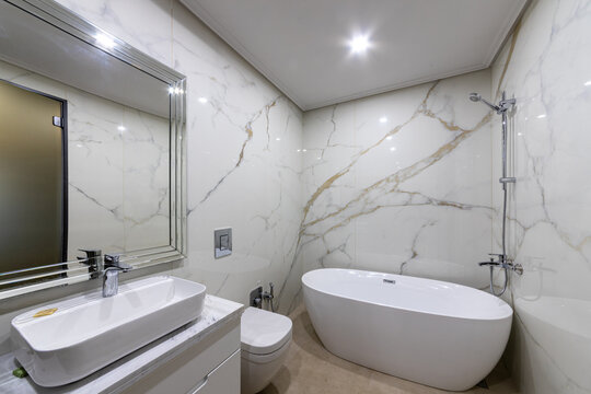 Clean bright stylish designer modern bathroom. Bathroom interior in luxury home with bathtub