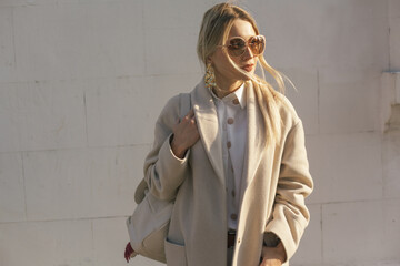 Fashion woman wearing beige coat on the street - 666595276