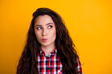 Photo of minded smart woman with wavy hairdo dressed checkered shirt thoughtfully look at empty...